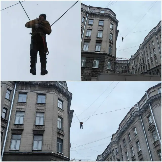 Дворник сорвался с крыши и повис на проводах дома
